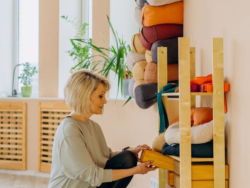 Minimalist yoga studio with warm lighting and wooden floor.